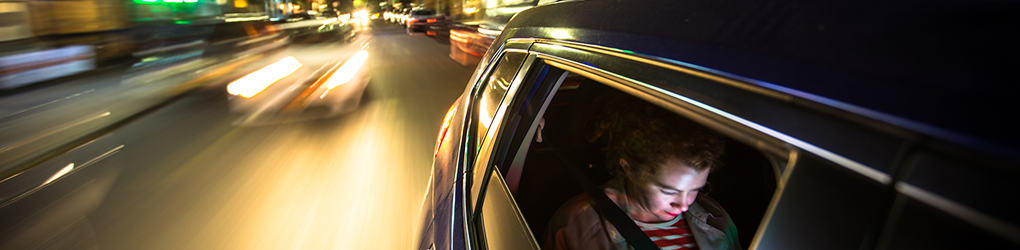 close up of a passenger in the back seat of a car in los angeles