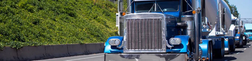 close up of the front of a semi truck on the road