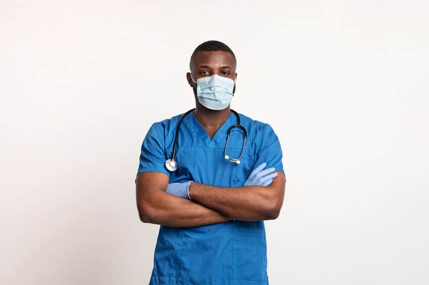 Confident black doctor in face mask and gloves