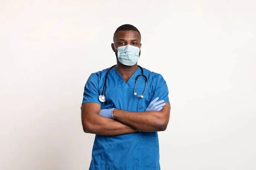 Confident black doctor in face mask and gloves
