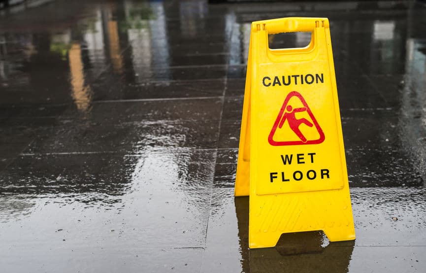 caution wet floor sign on a slippery floor