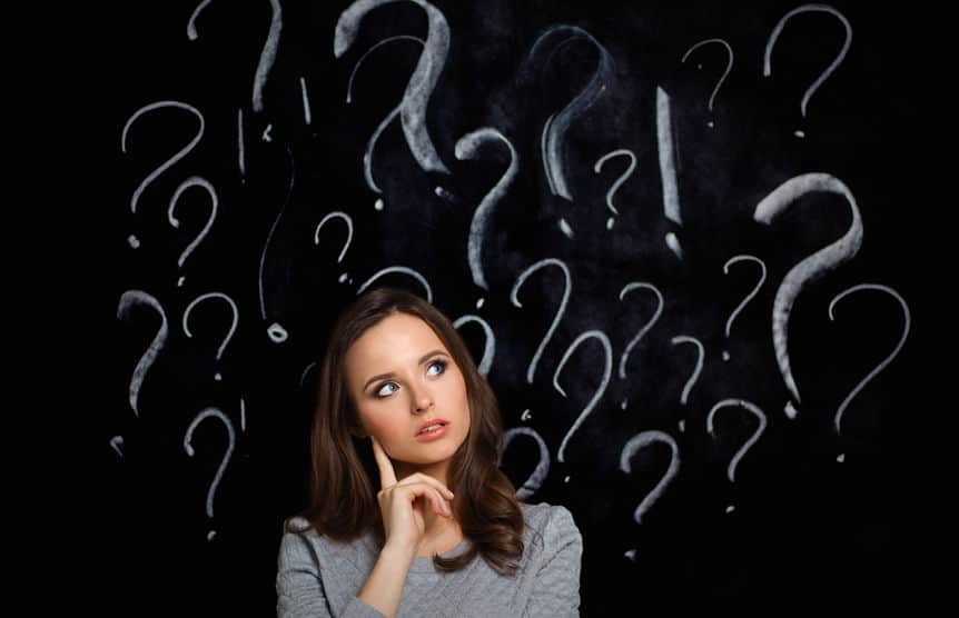 woman with question marks above her head on a gray background