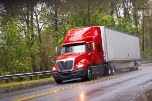 Semi truck driving on a wet road