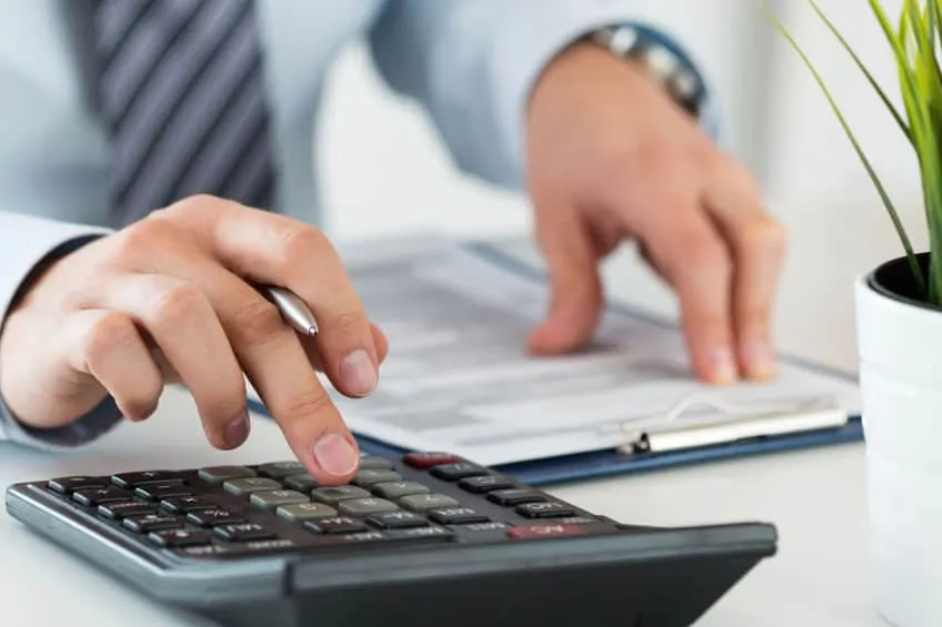 close up of an accountant or banker calculating insurance