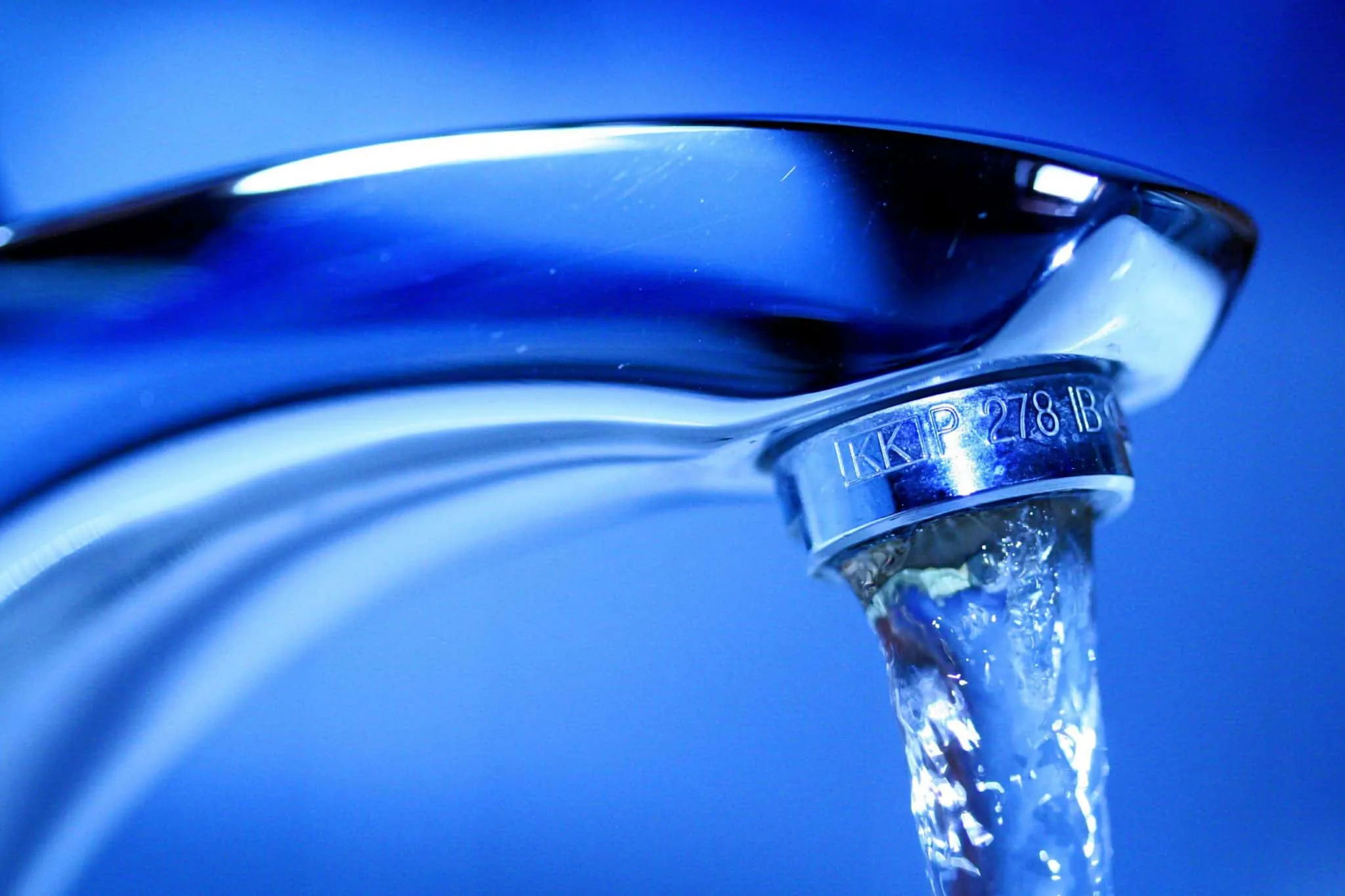 close up of a faucet and running water