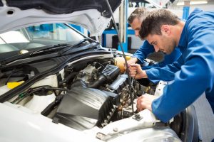 Team of mechanics working together at the repair garage