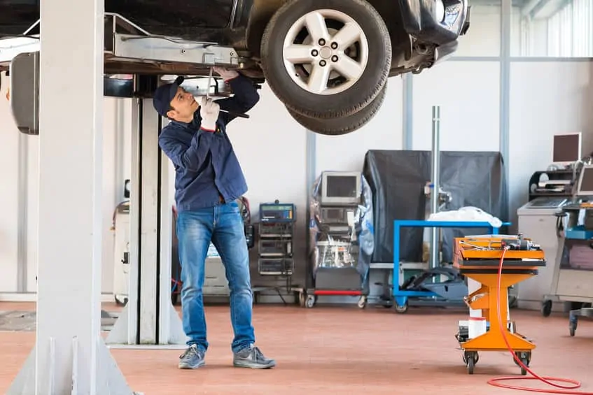 Mechanic repairing a car in a garage after a car accident