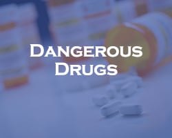 Dangerous Drugs - blue overlay on pill bottle tipped over with pills scattered across a table