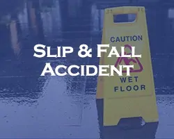 Slip And Fall Accident - blue overlay on a caution wet floor sign with a wet floor