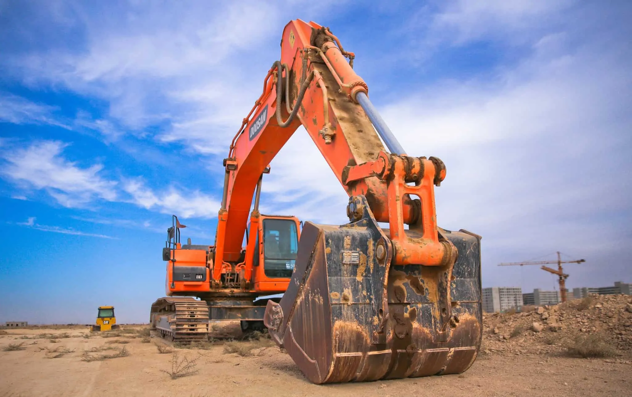 construction equipment digging into the ground at a work site