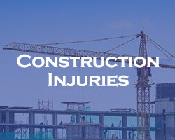 Construction Injuries -- blue overlay on a view of a construction site and crane