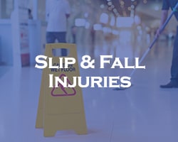 Slip & Fall Injuries -- blue overlay on a wet floor sign and people cleaning the floor behind it
